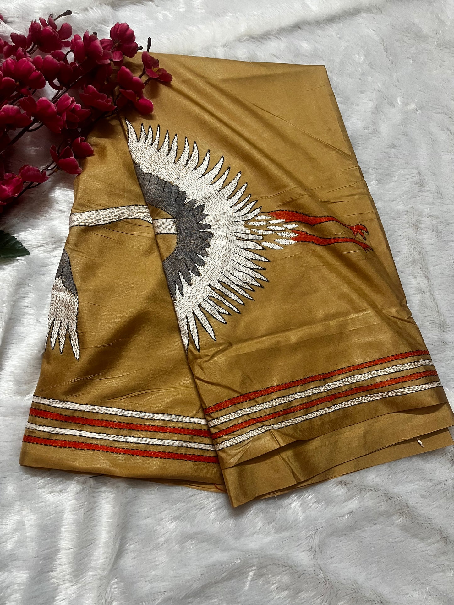 Close-up of handcrafted kantha stitch crane embroidery on beige handwoven cotton fabric