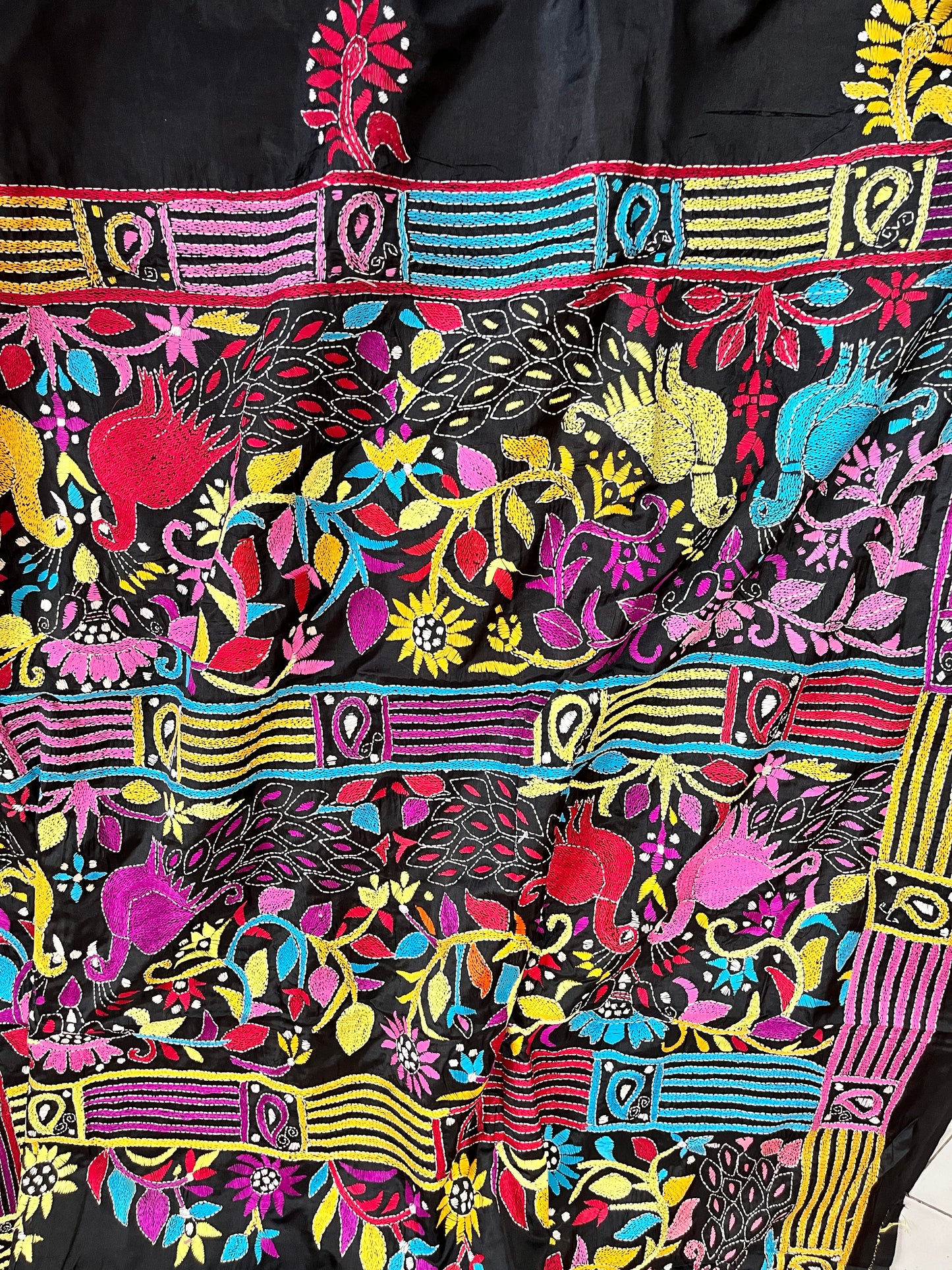 Close-up of peacock motif kantha embroidery on black Bangalore Silk fabric