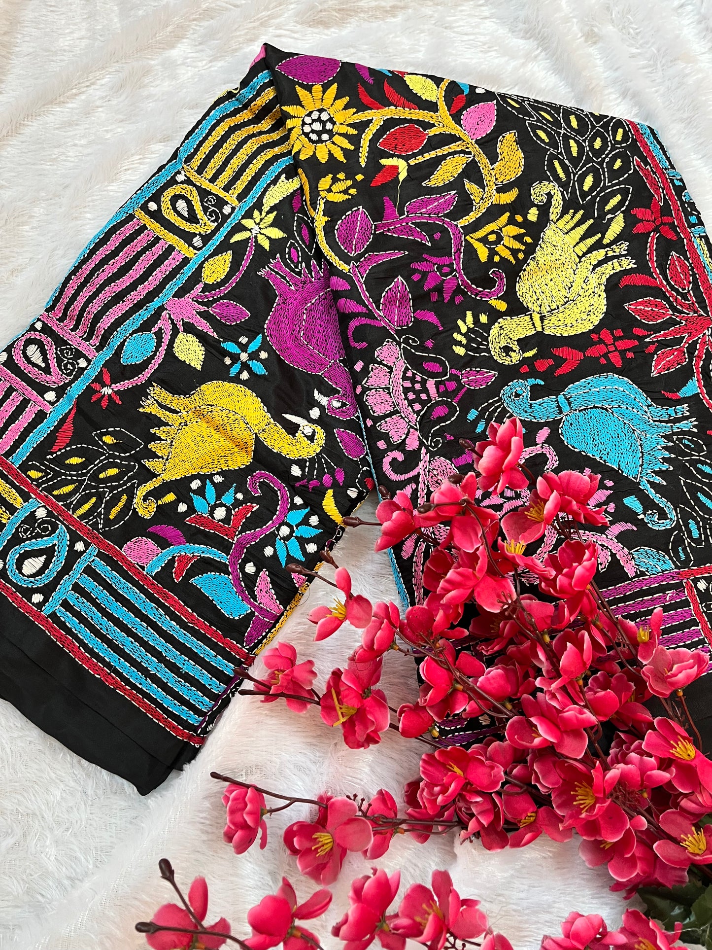 Close-up of peacock motif kantha embroidery on black Bangalore Silk fabric