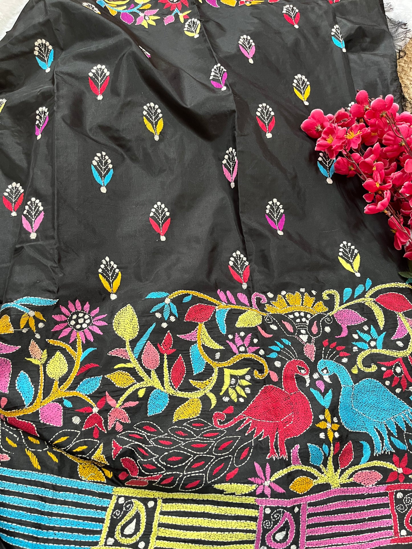 Matching black blouse piece with coordinating peacock kantha details
