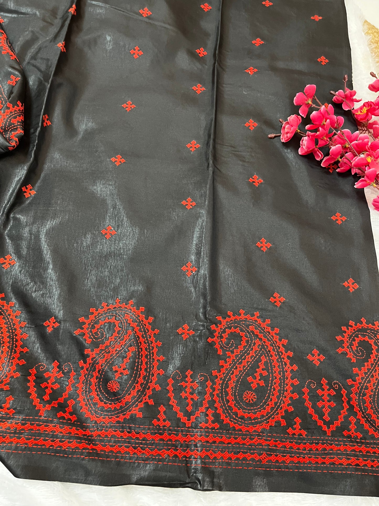 Detailed texture of handwoven Bangalore silk with raised red thread paisley embroidery