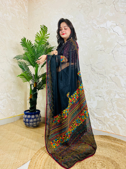 Beautiful woman in pure Black Organza Saree showcasing vibrant Bullion Stitch and French knot embroidered pallu — exclusive handcrafted ethnic wear by Desi Aadat