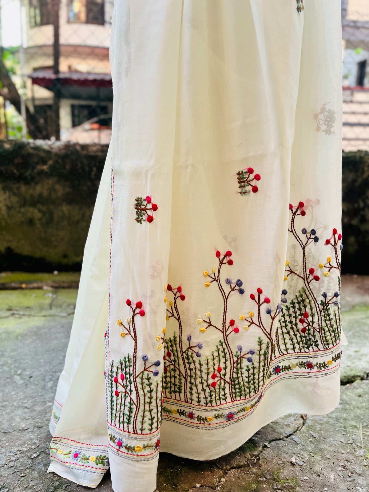 Close-up of handcrafted Bullion Stitch and French Knot wildflower meadow embroidery on cream Chanderi silk cotton saree pallu — outdoor view, Desi Aadat