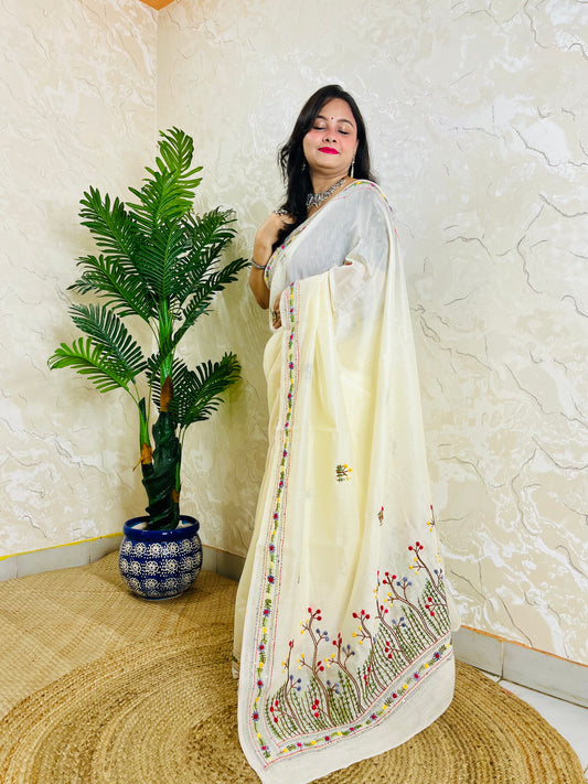 Handcrafted cream Chanderi silk cotton saree with multicolour French Knot and Bullion Stitch forest embroidery — standing indoor view, Desi Aadat
