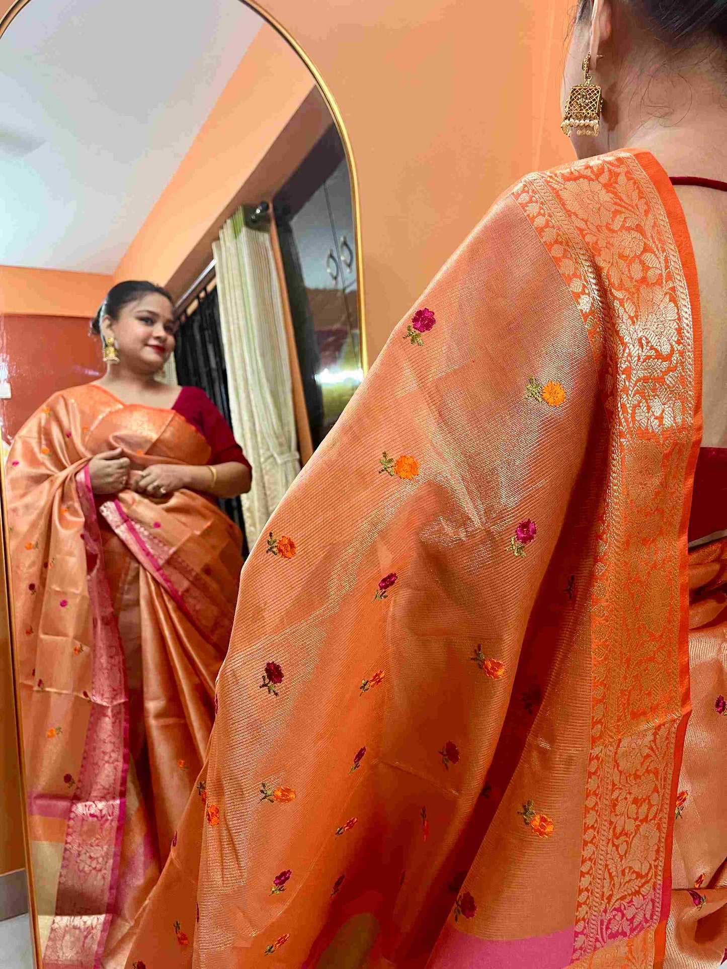 Stylish woman in Orange tissue saree showcasing Desi Aadat’s handwoven design