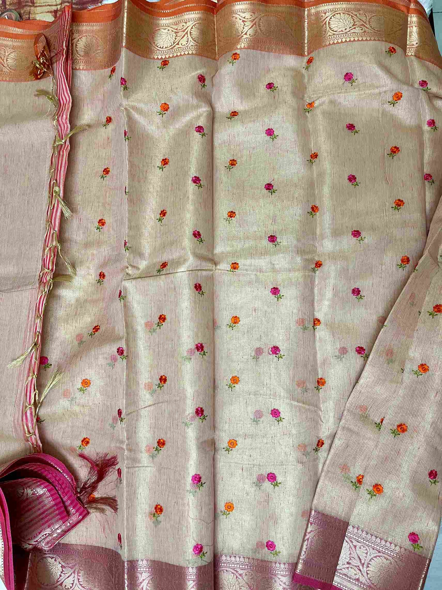 Close-up of embroidery on Pink cotton tissue saree fabric