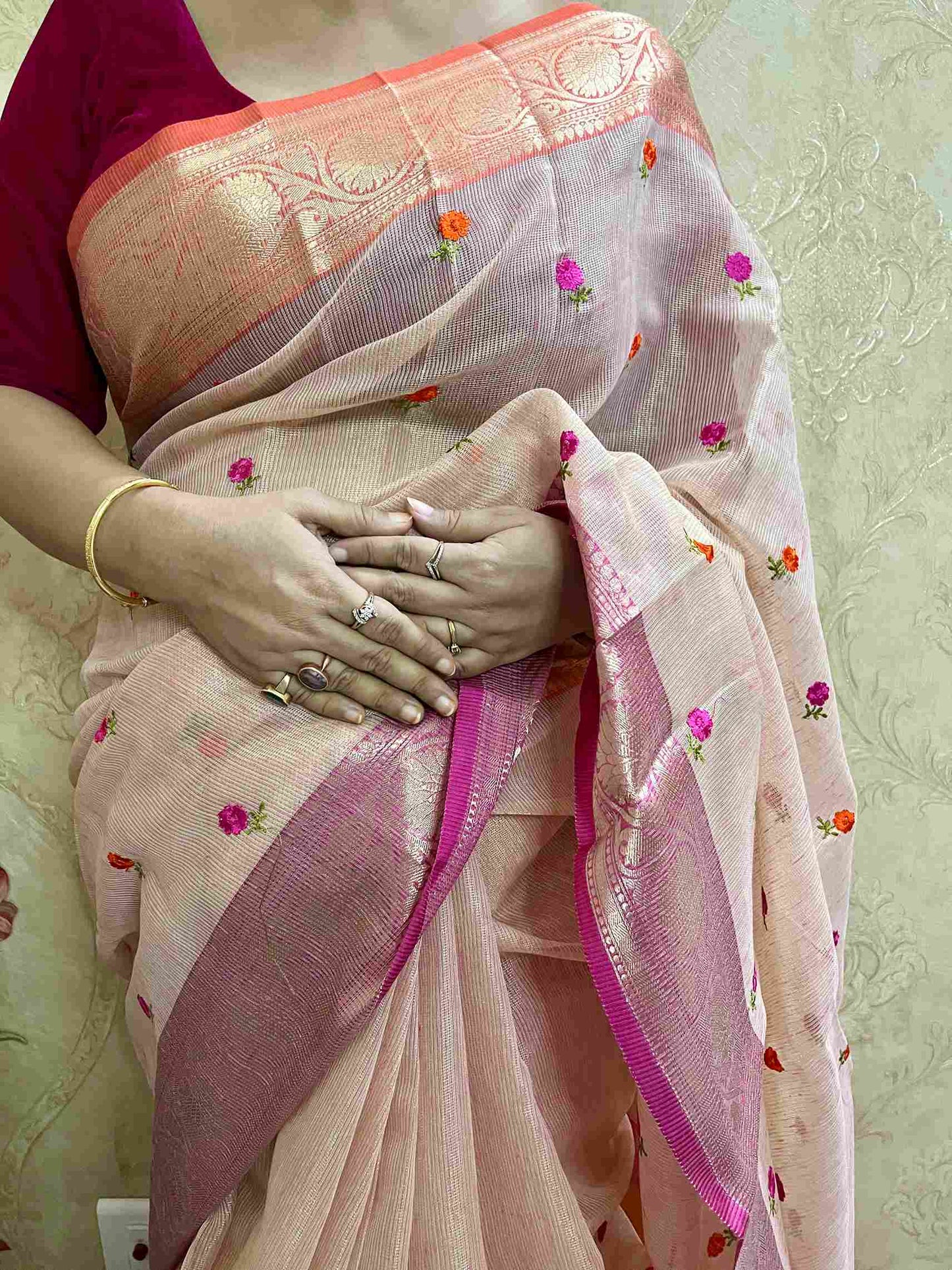 Close-up of embroidery on Pink cotton tissue saree fabric