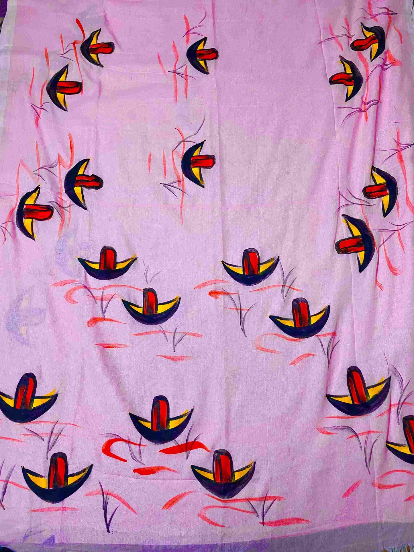 A woman draped in a soft mul mul cotton saree with exquisite hand-painted artwork.