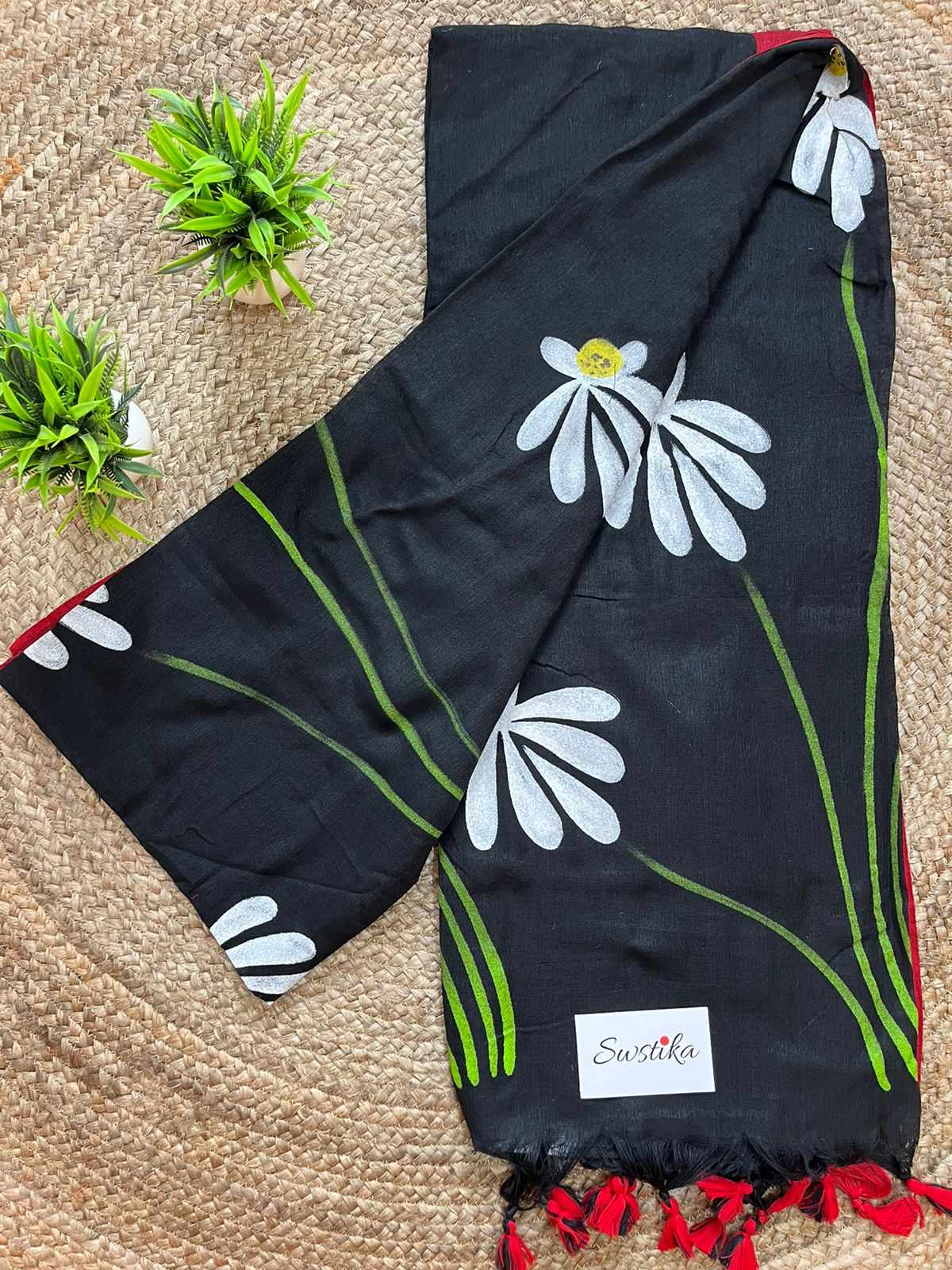 Luxury handwoven black mul-mul cotton saree with artistic hand-painted details.