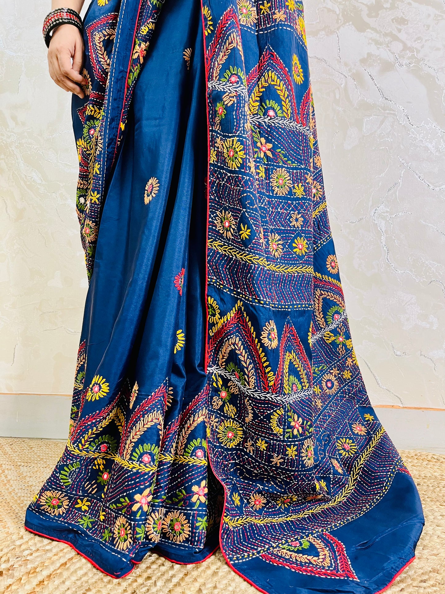 Close-up detail of arch pattern Lambani embroidery on deep indigo silk saree