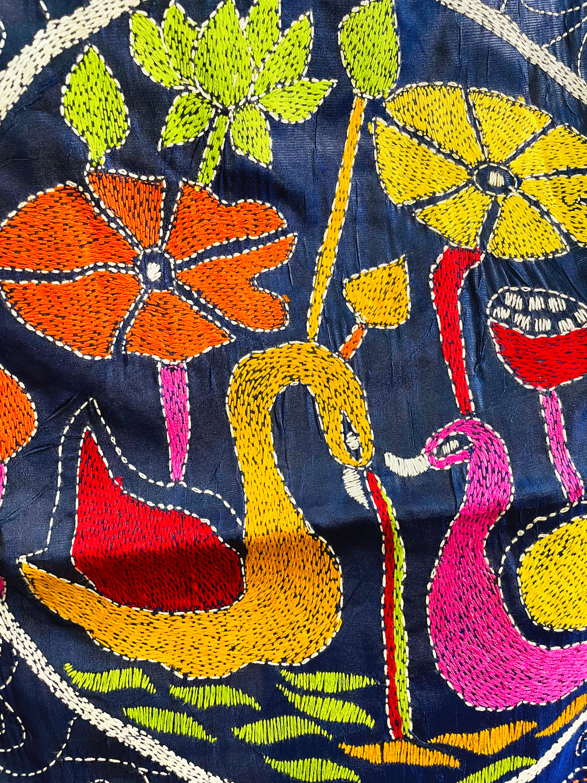 Close-up of hand-stitched swan medallion motif on ink blue Kantha saree