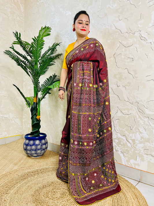 Woman wearing burgundy Bangalore silk saree with Lambani hand embroidery, side standing