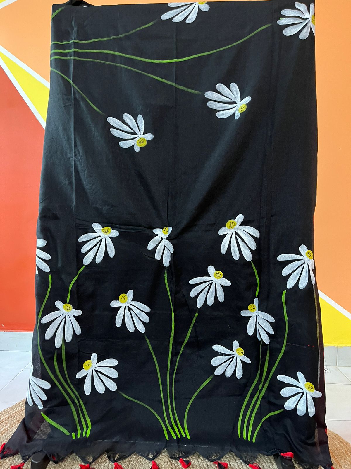 Luxury handwoven black mul-mul cotton saree with artistic hand-painted details.