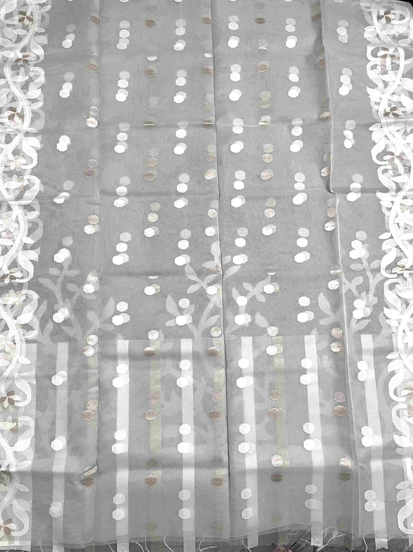 Close-up of Jamdani muslin saree motifs on Light Grey silk fabric