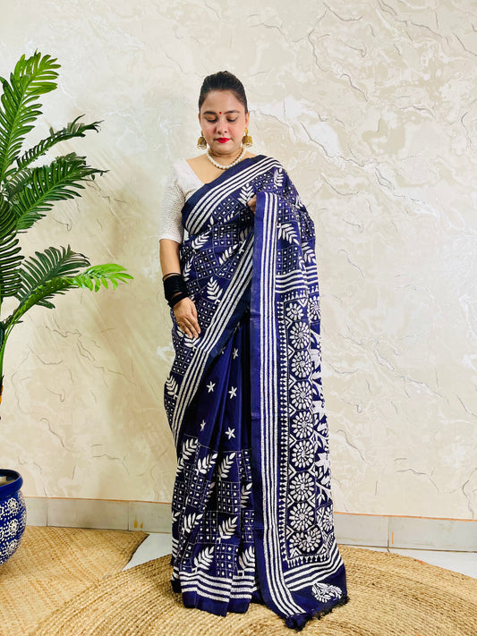 Full front view of a woman modeling the navy blue handcrafted saree, revealing the leaf motif body and multi-striped border work.