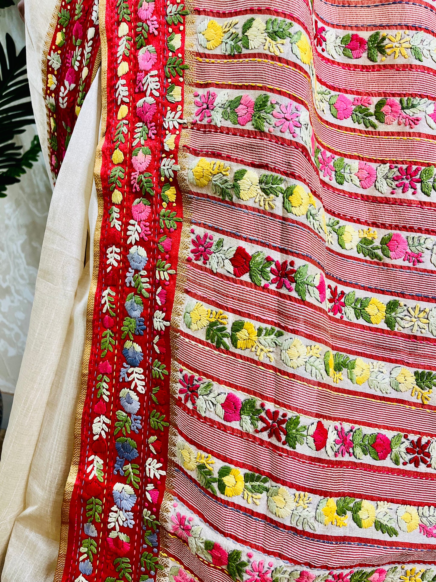Close-up of Parsi Gara hand-embroidered horizontal floral garden stripes with Kardana work on handwoven Semi Muga Silk saree with red velvet border — Desi Aadat