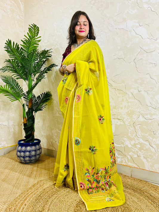 Lemon yellow Parsi Gara handwork Chanderi silk cotton saree with scattered butti florals and multicolour garden border — standing front view, Desi Aadat