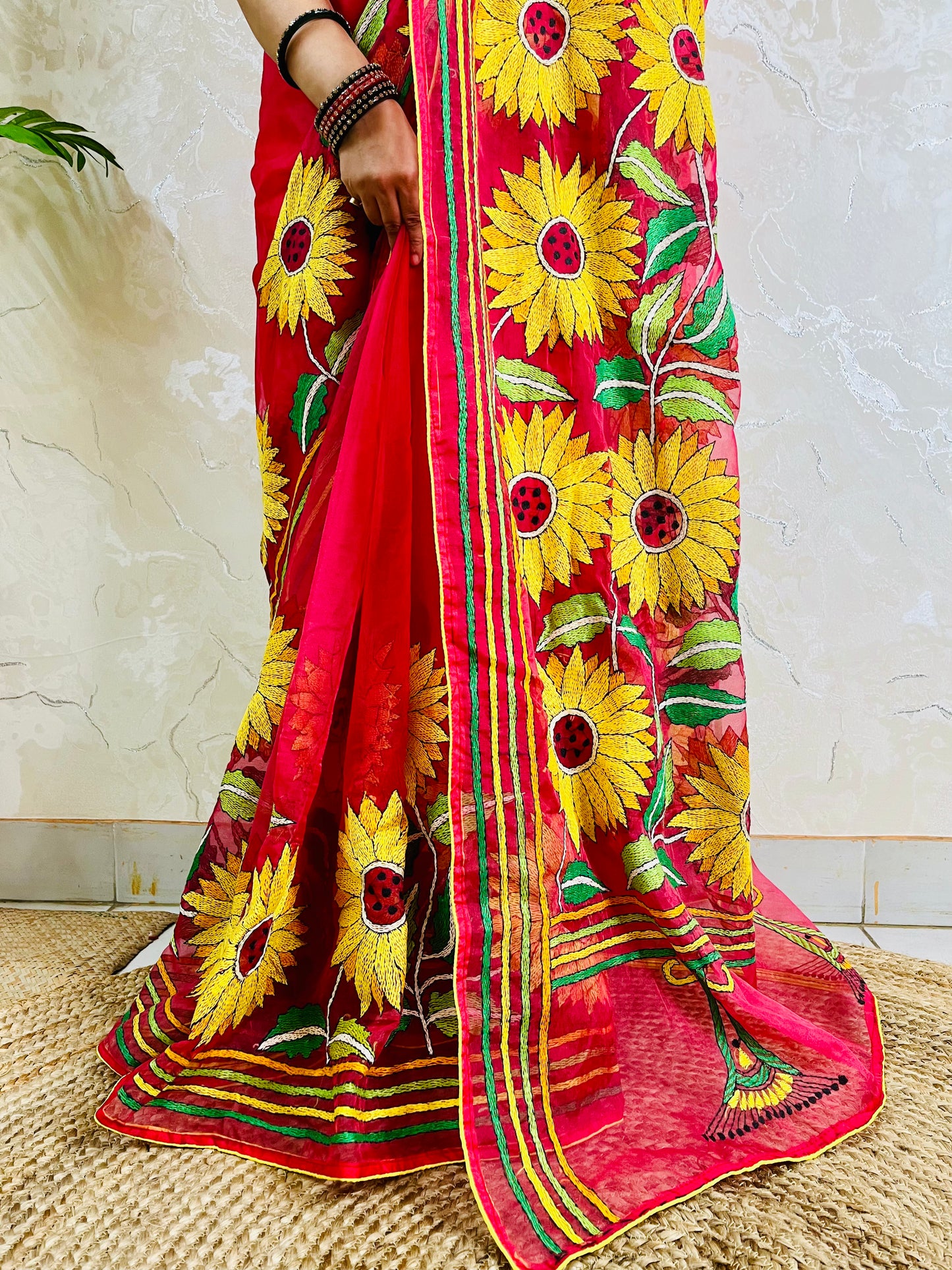 Lower hemline detail of crimson red sunflower Kantha stitch saree