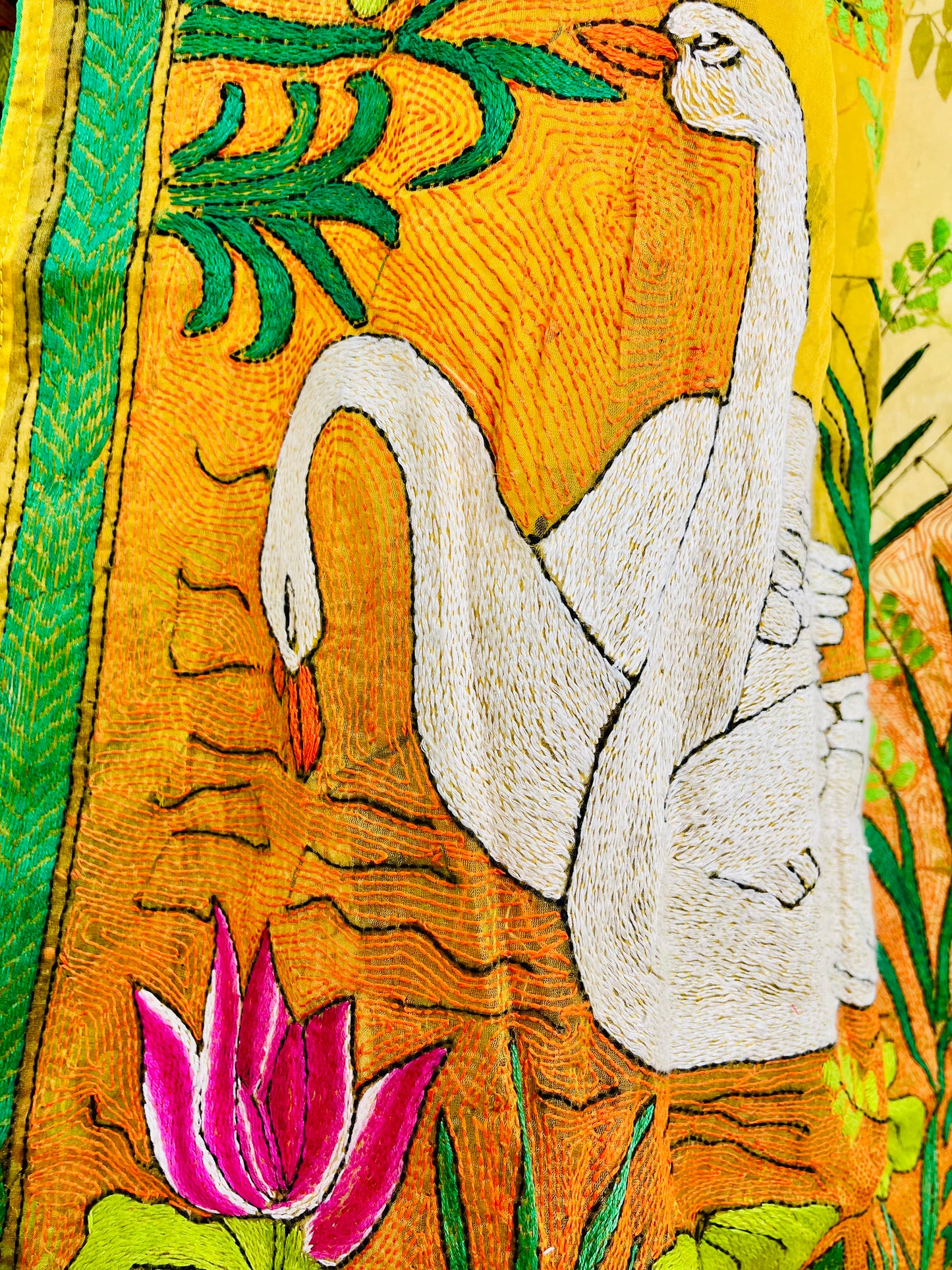 Close-up of hand-embroidered swan lotus Kantha stitch on sunshine yellow organza