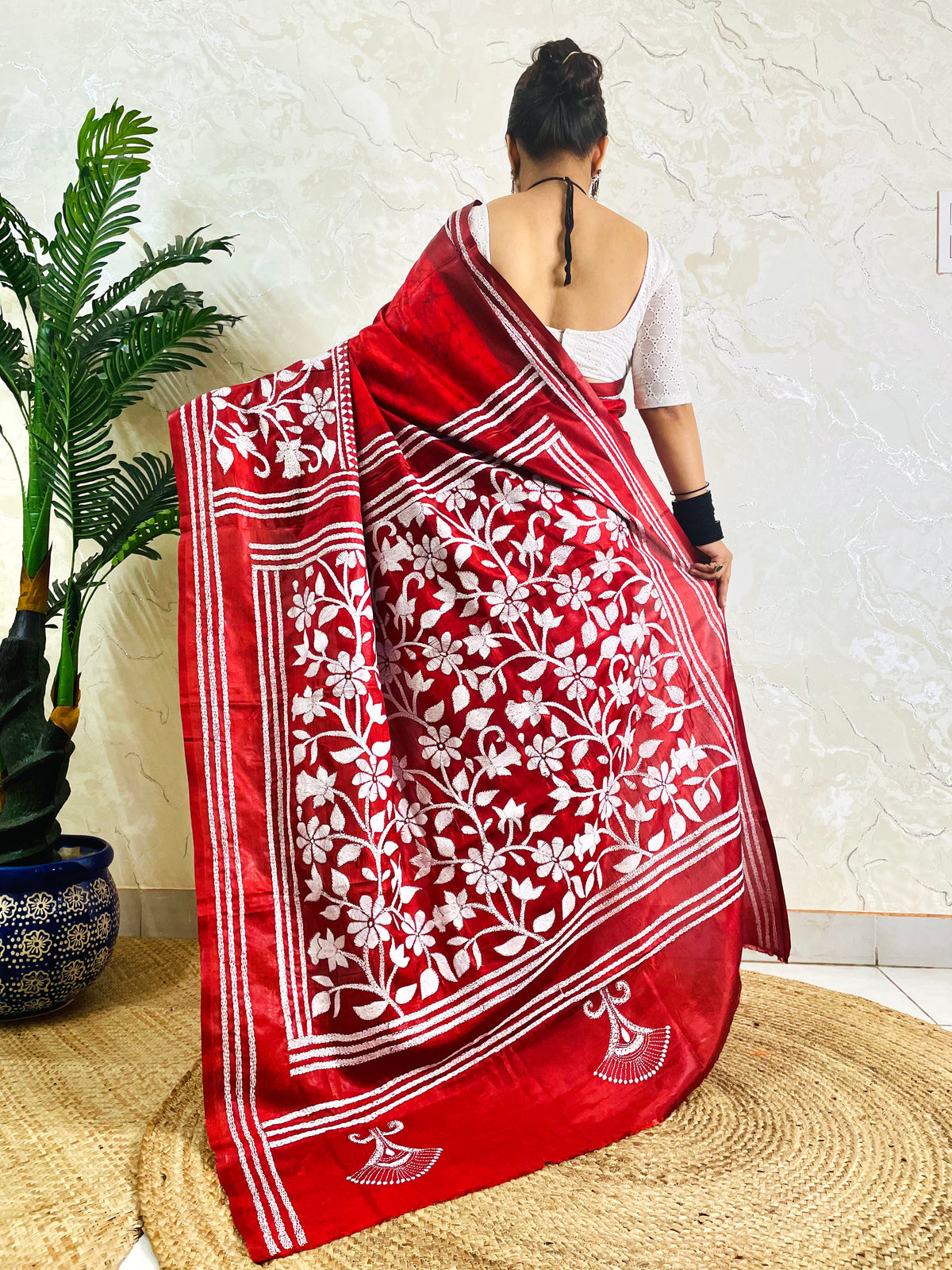 Back view of crimson red batik Bangalore silk saree with white Kantha flower and leaf pallu