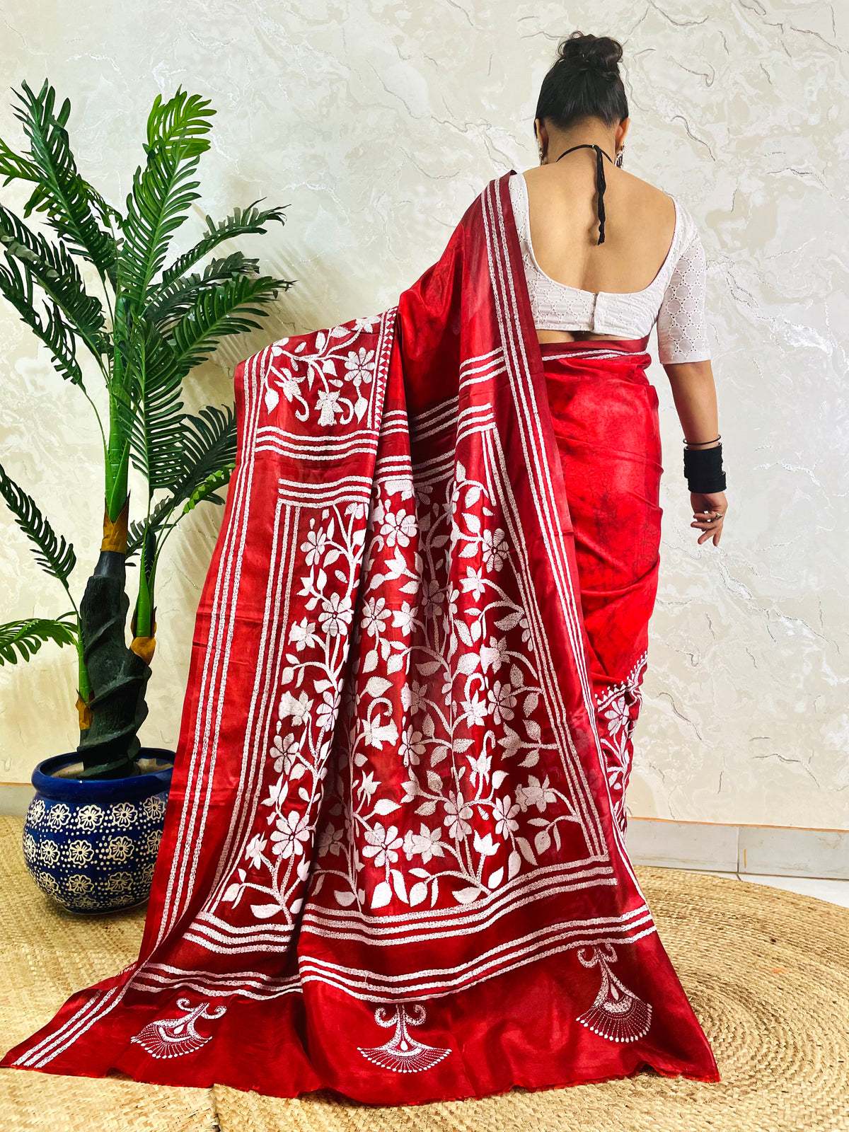 Back view of crimson red batik Bangalore silk saree with white Kantha flower and leaf pallu