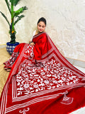 Seated pose in crimson red batik Kantha stitch saree with white flower and leaf pallu on Bangalore silk