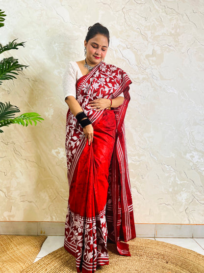 Standing pose showing crimson batik Kantha saree hem with white flower and leaf band