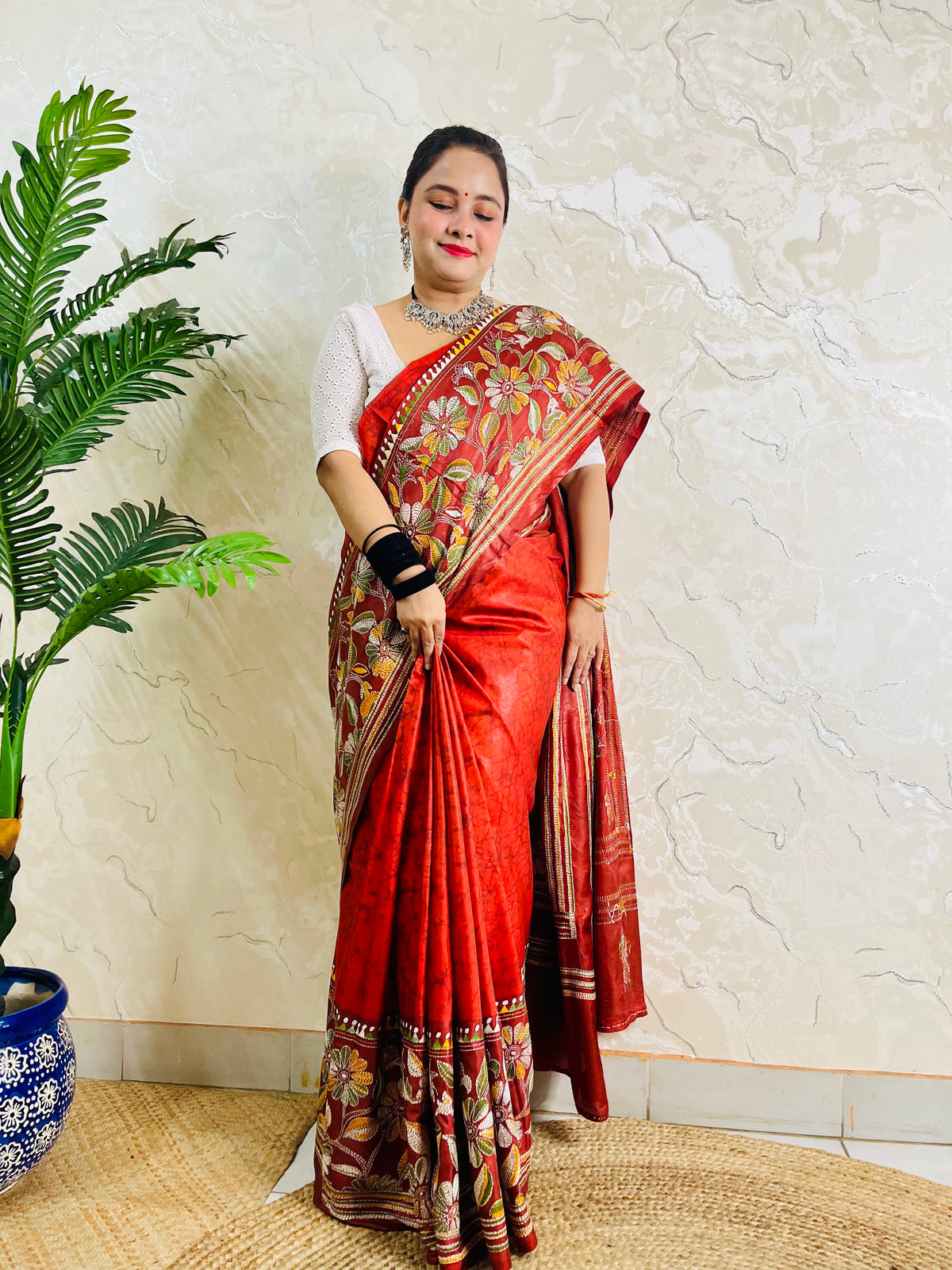 Front view of rust red batik Kantha saree on Bangalore silk with floral pallu
