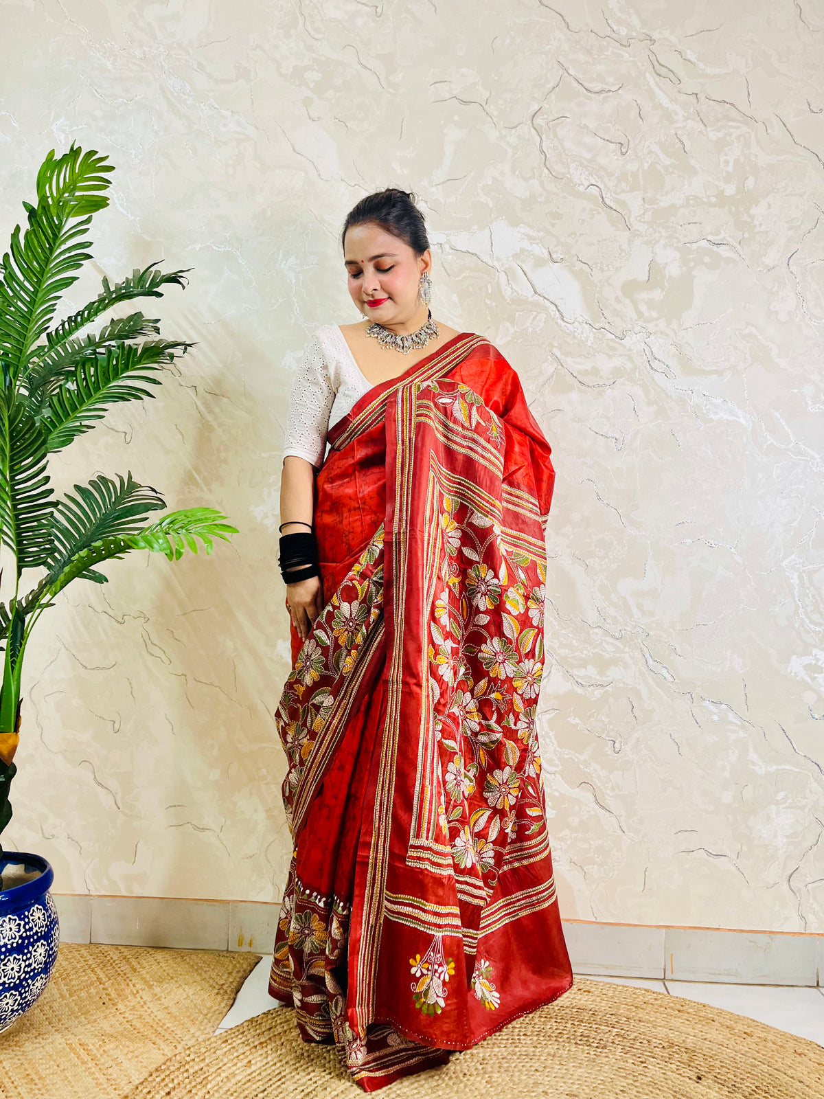Front view of rust red batik Kantha saree on Bangalore silk with floral pallu