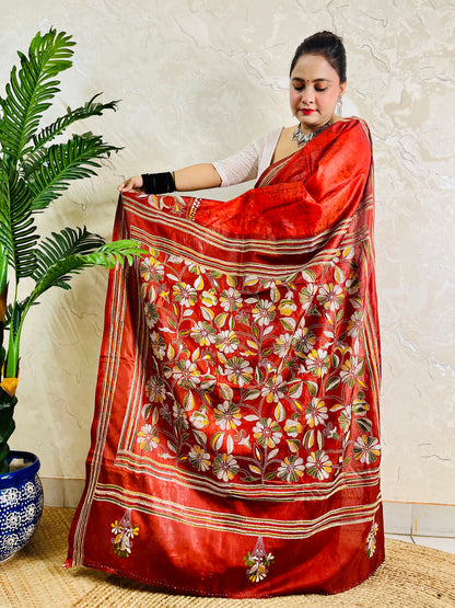 Side view of rust red Kantha stitch saree pallu with flower and leaf motifs