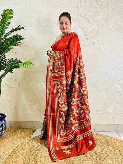Side view of rust red Kantha stitch saree pallu with flower and leaf motifs