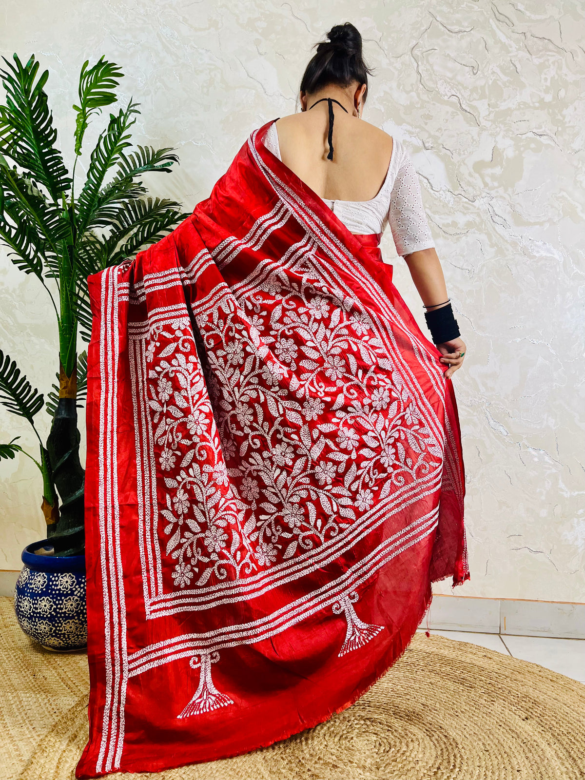 Back view of crimson red batik Kantha saree with floral border pallu