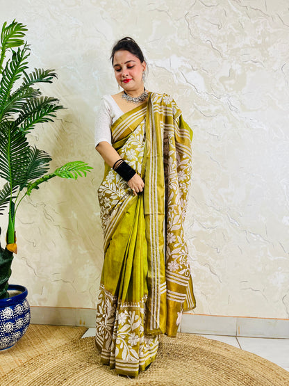 Full front view of a woman draped in the affordable luxury olive green Batik Katha silk saree showing the front pleats and pallu