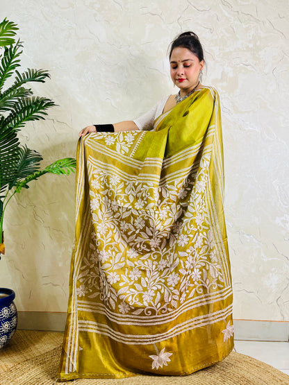Woman wearing the handmade olive green Bangalore silk saree featuring traditional Batik Katha work and intricate border details