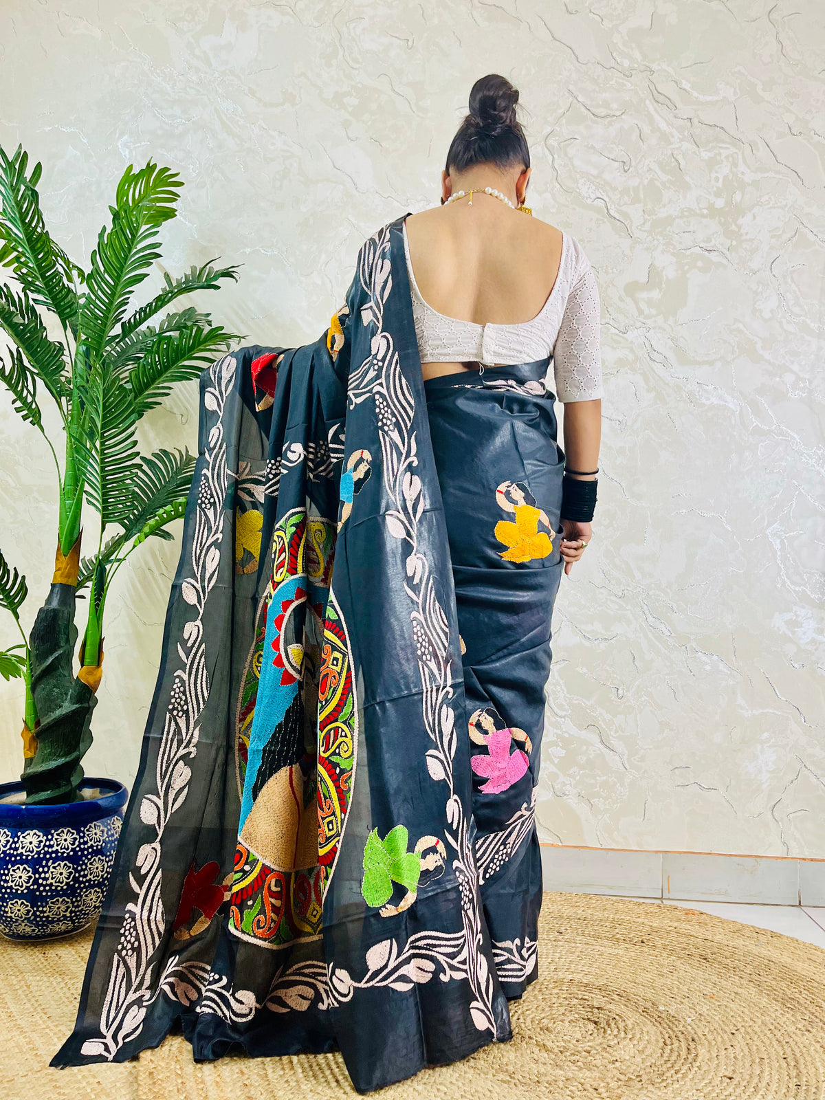 Back view of black blended Bangalore silk saree with Kantha face portrait pallu and figure motifs