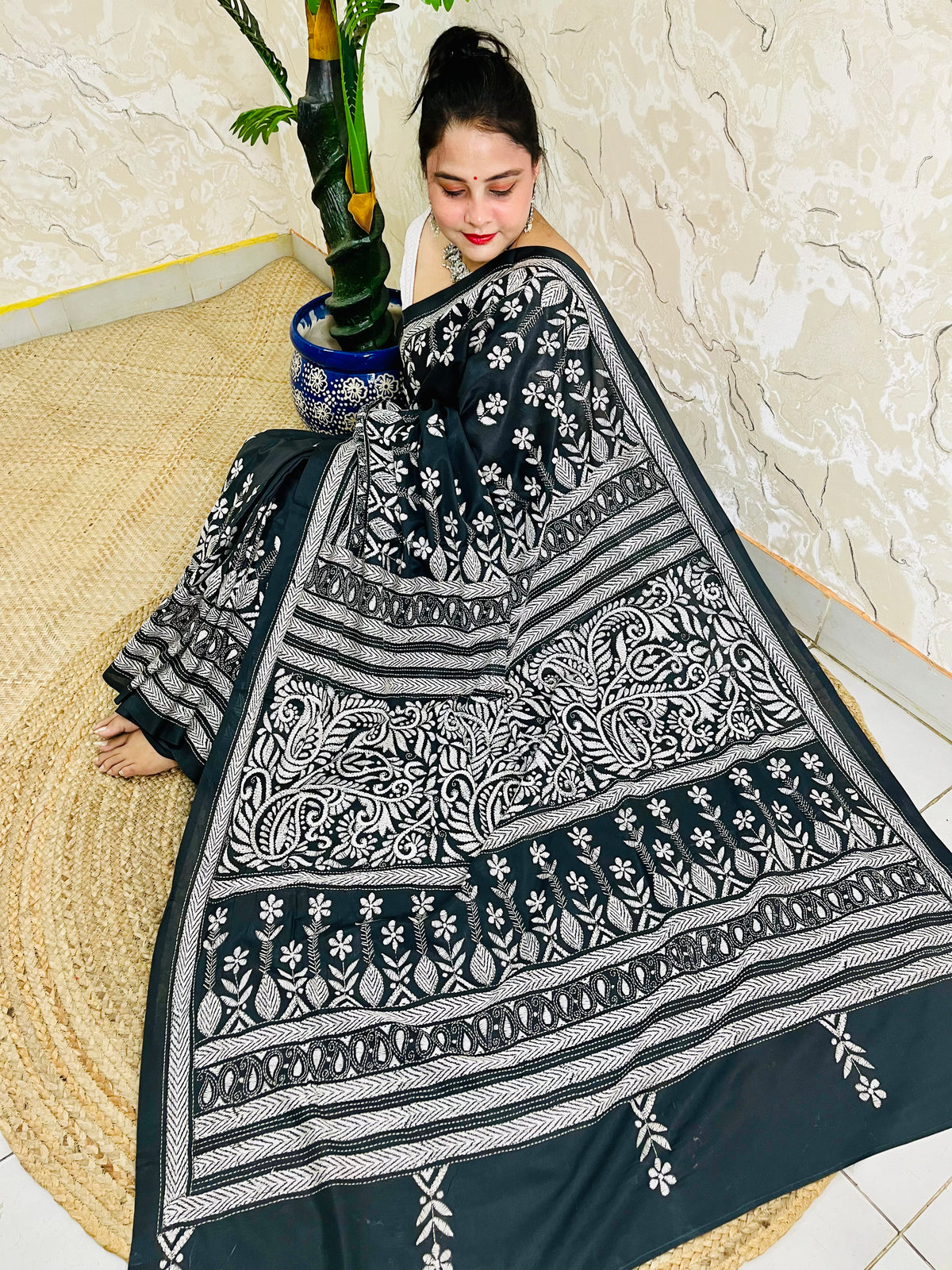Front view of model wearing the affordable luxury black Bangalore silk saree with white Katha stitch floral and geometric detailing
