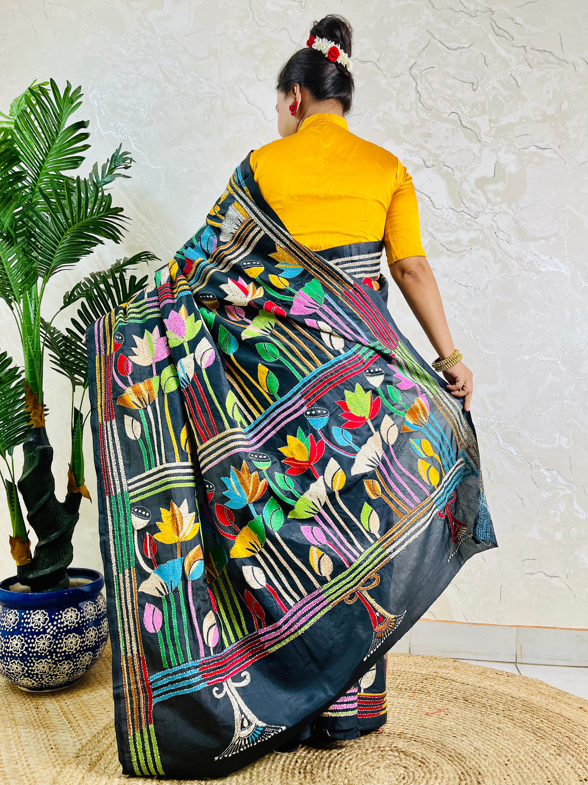 Black Kantha stitch saree with multicolour lotus motif, back standing view