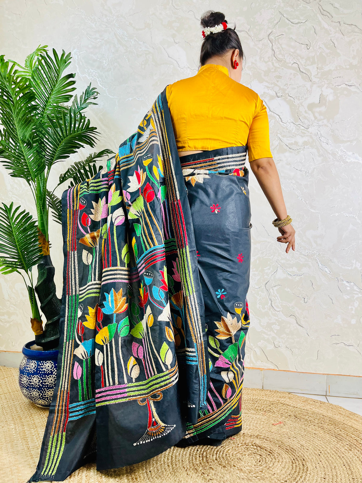 Black Kantha stitch saree with multicolour lotus motif, back standing view