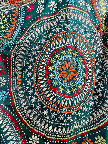 Extreme close-up of the detailed Katha stitch running embroidery, depicting multi-colored concentric circles and floral patterns within the Mandala.