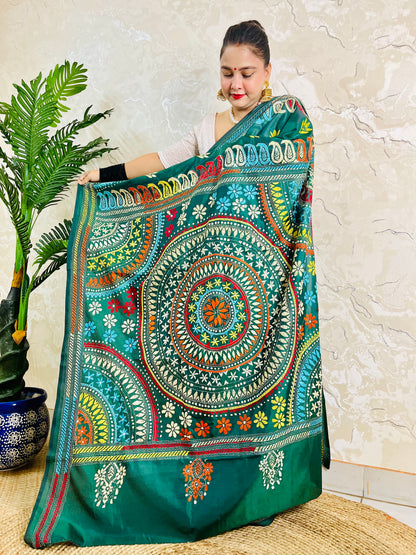 Full-length display of the handcrafted saree, highlighting the multi-colored Katha stitch Mandala center and paisley border on the pallu.