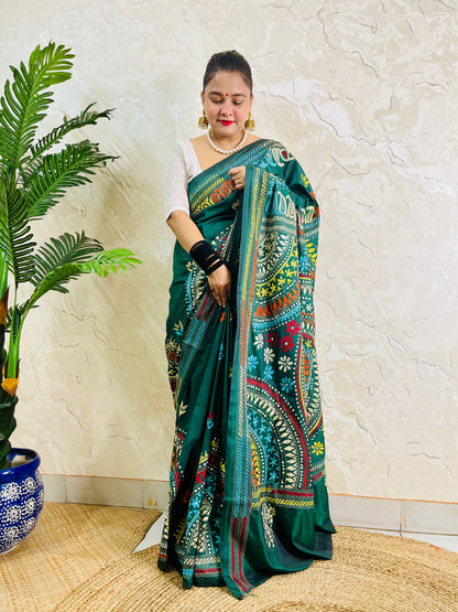 Model wearing the bottle green silk saree, showing the elegant drape of the embroidered pallu and subtle floral bootis on the pleats.
