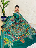 High-angle sitting pose displaying the spread-out hand-embroidered Mandala artwork and vibrant geometric thread work on deep bottle green silk.