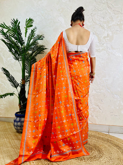 Back view of orange handwoven saree showing Kutch work embroidery pattern