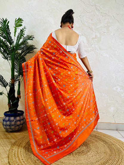 Back view of orange handwoven saree showing Kutch work embroidery pattern