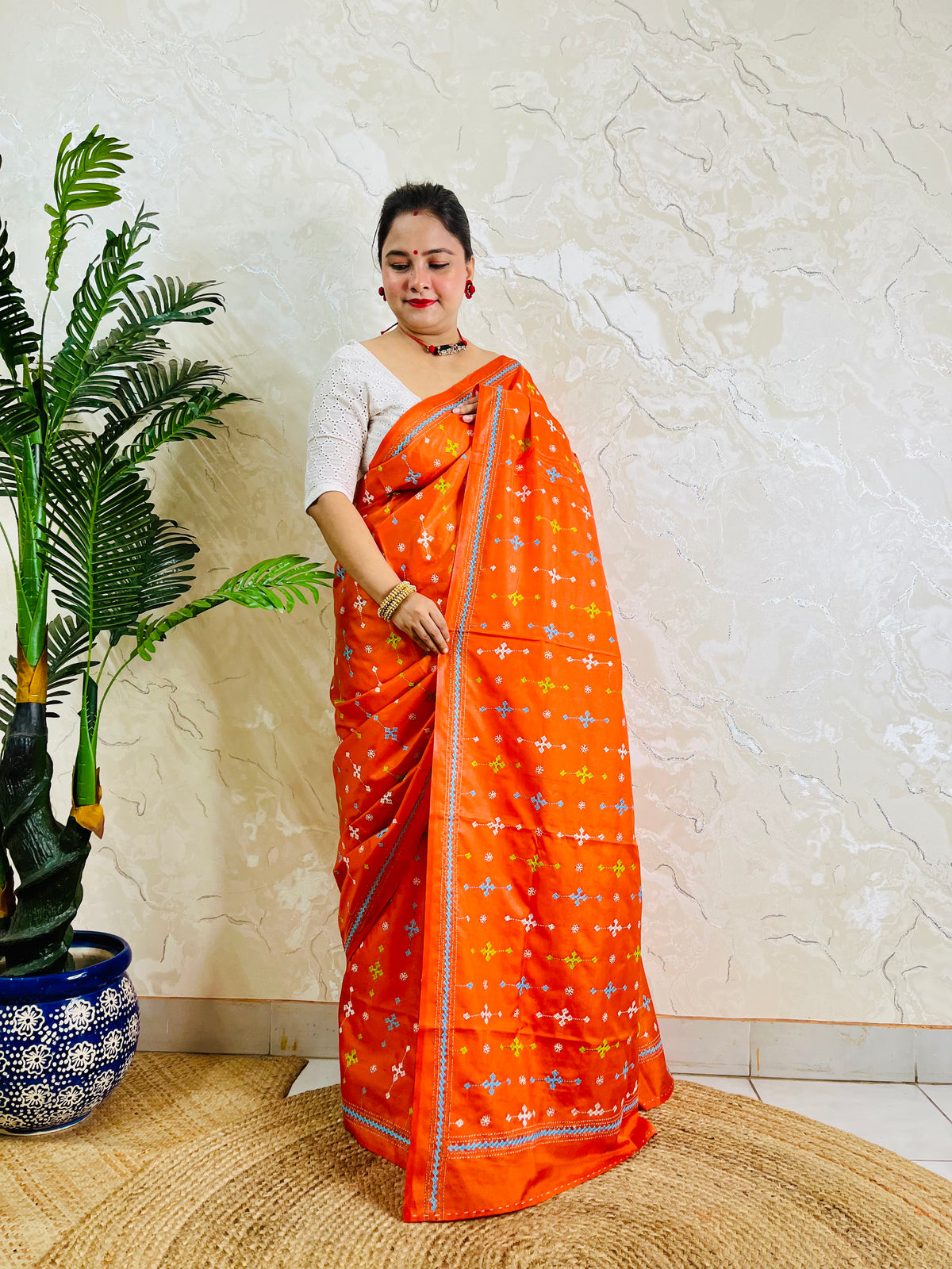 Bright orange Gujarati stitch saree on Bangalore silk, full drape standing pose