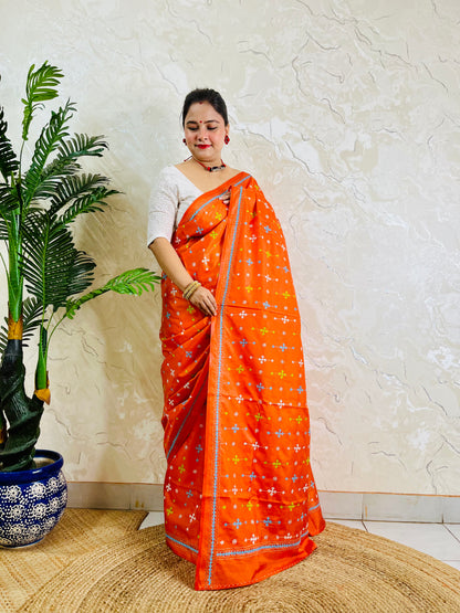 Bright orange Gujarati stitch saree on Bangalore silk, full drape standing pose