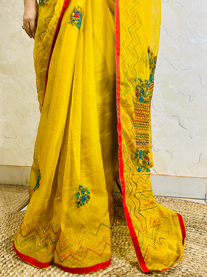 Close-up of Bullion Stitch florals and French knot embroidery on handcrafted mustard yellow pure organza silk saree — Desi Aadat