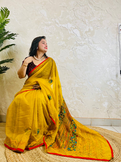 Mustard yellow handmade organza silk saree with multicolour Bullion Stitch and zigzag running stitch embroidery — side sitting drape view, Desi Aadat