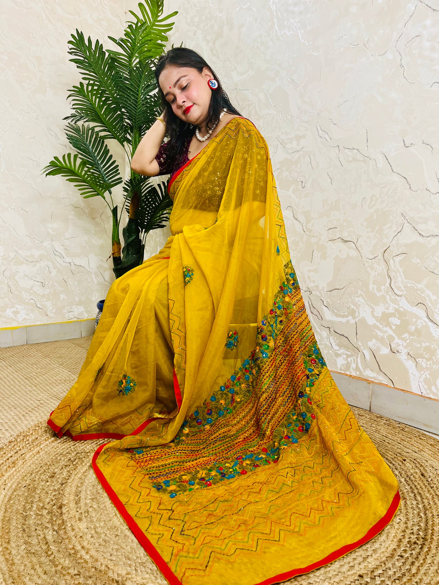 Mustard yellow handmade organza silk saree with multicolour Bullion Stitch and zigzag running stitch embroidery — side sitting drape view, Desi Aadat