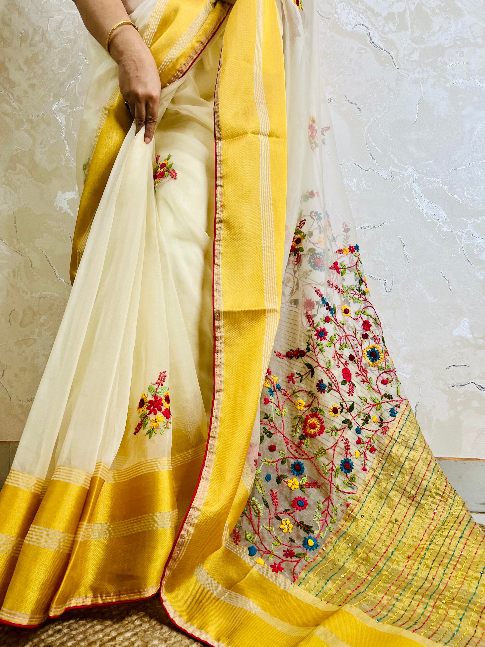 Close-up of Bullion Stitch wild floral and French knot hand embroidery on off white pure organza silk saree with yellow border — Desi Aadat